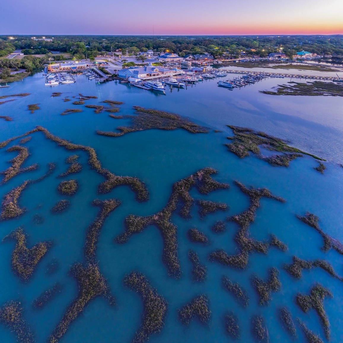 Aerial view of the inlet in Murrells Inlet with buildings in the distance