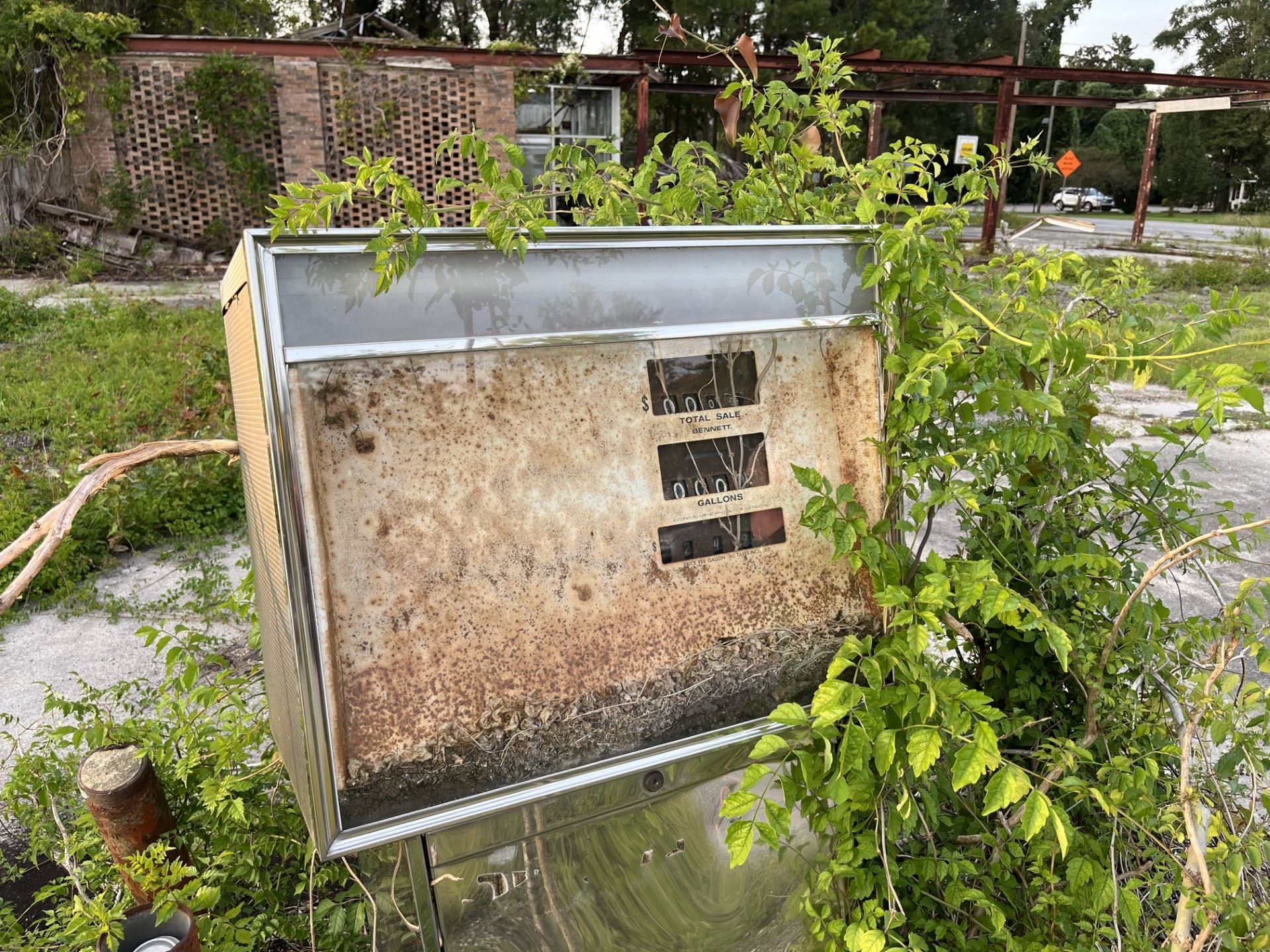 A rusted gas pump at an abandoned gas station