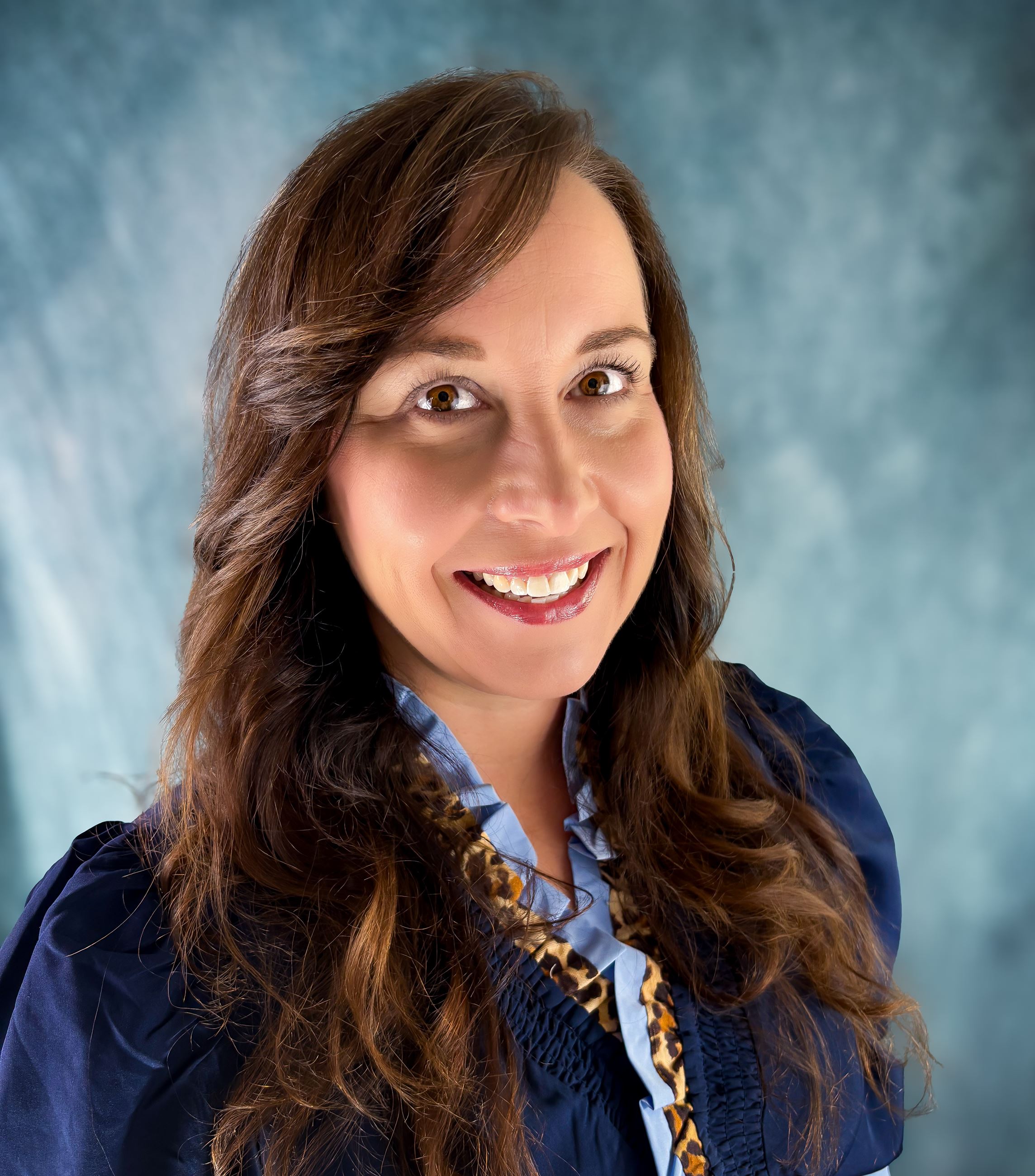 Portrait of Carla Harvey, a white woman with long dark hair and dark eyes.